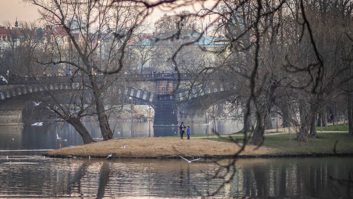 family playing along Vltava River