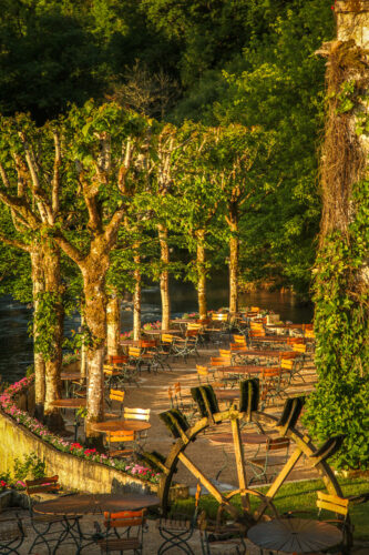 Le Moulin de l'Abbaye terrace and waterwheel