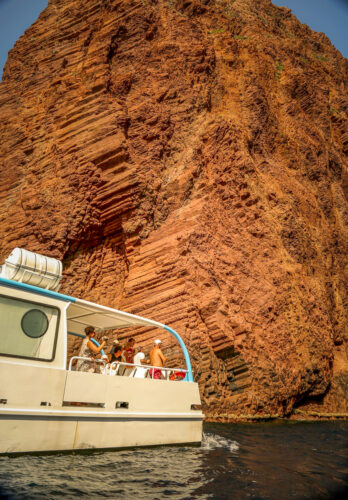Scandola Nature Reserve tour boat against rocks