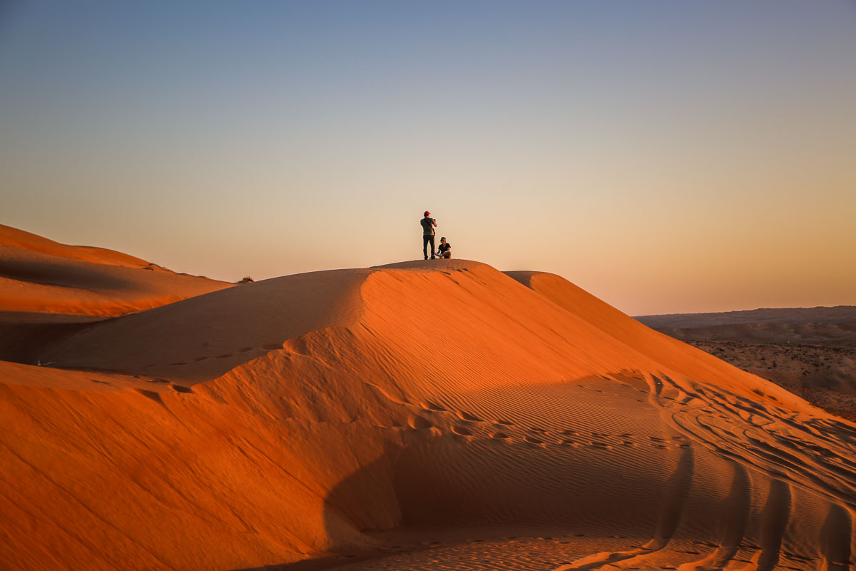 People on dunes Wahiba Sands Oman