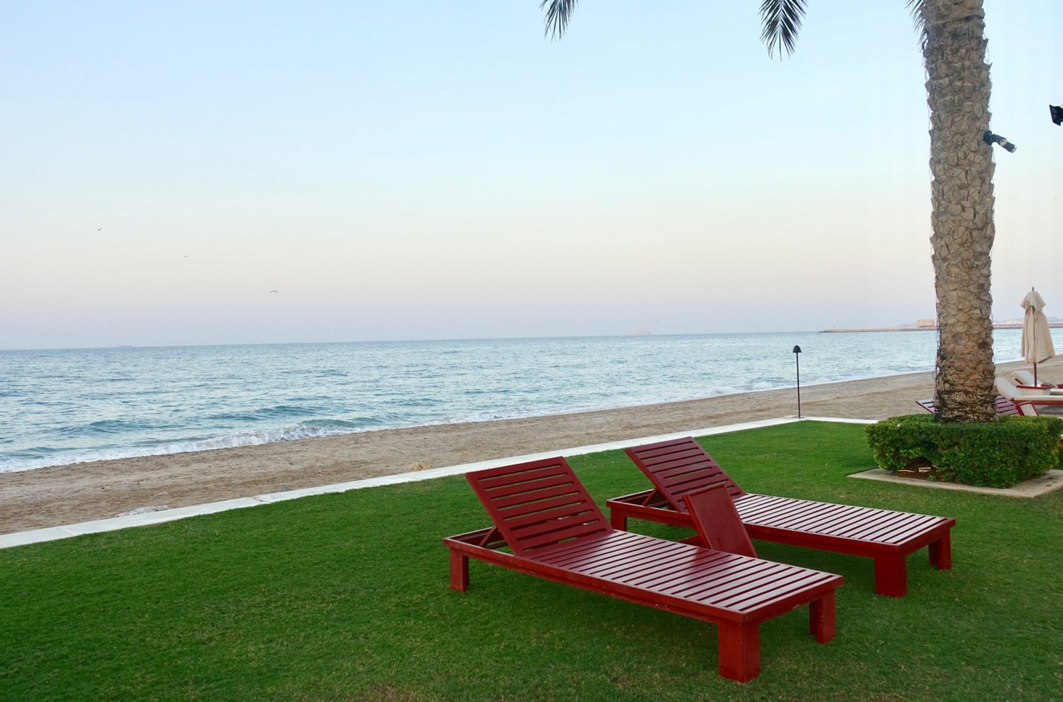 Chedi Muscat beach chairs at dusk