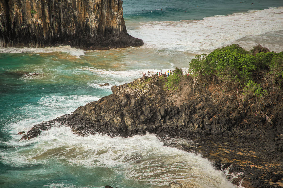 people on rocks Dois Irmãos Fernando de Noronha