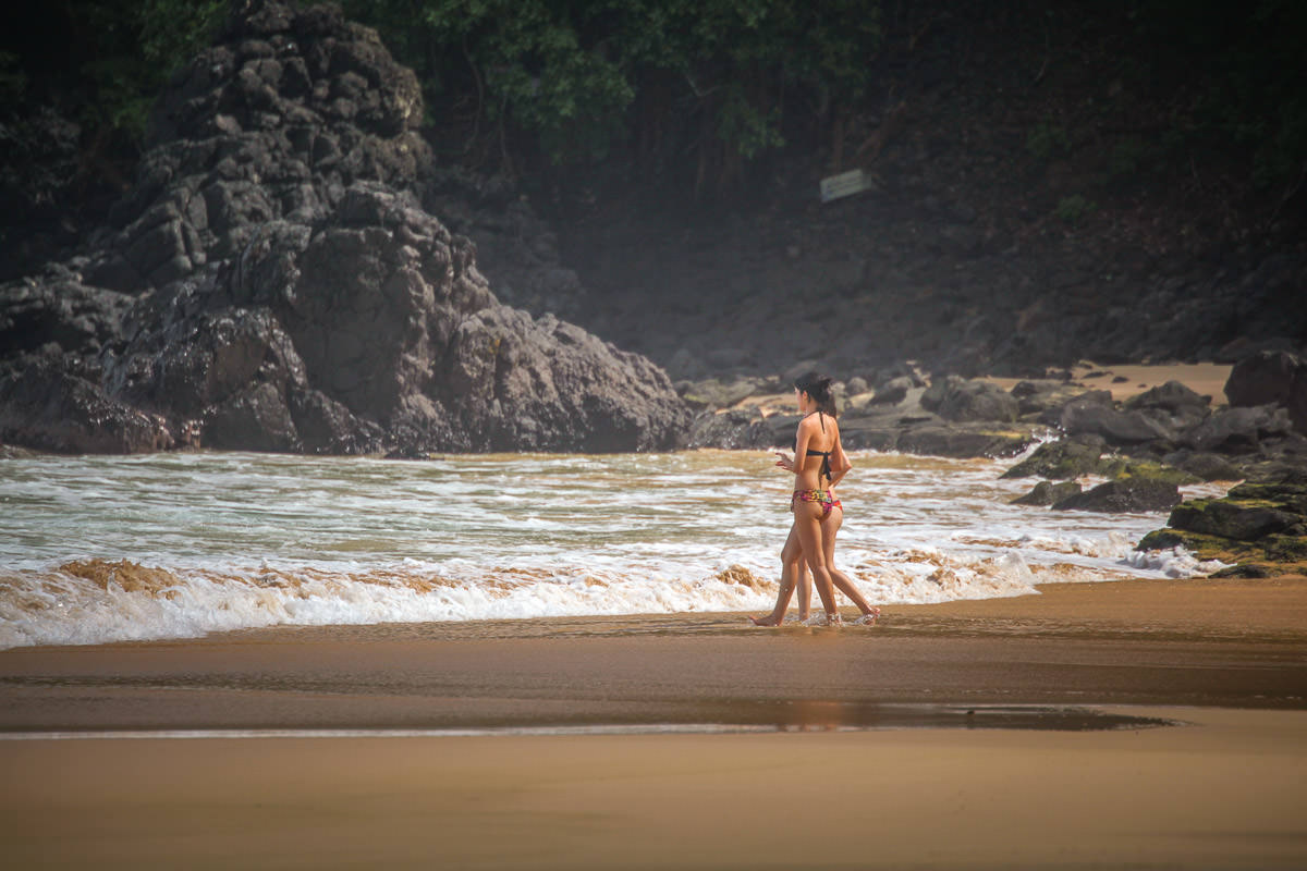 people walking Praia do Sancho Fernando de Noronha