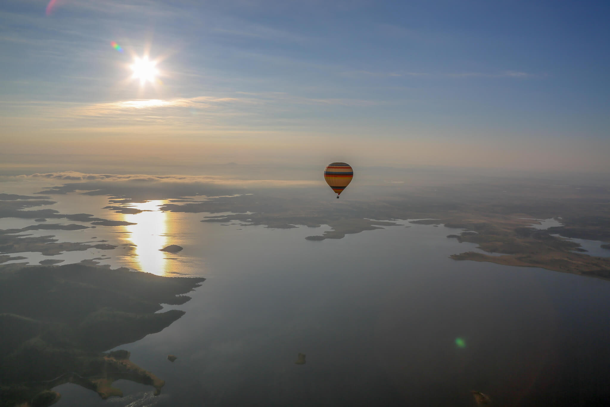 Balloon over Alqueva Reservoir at sunrise