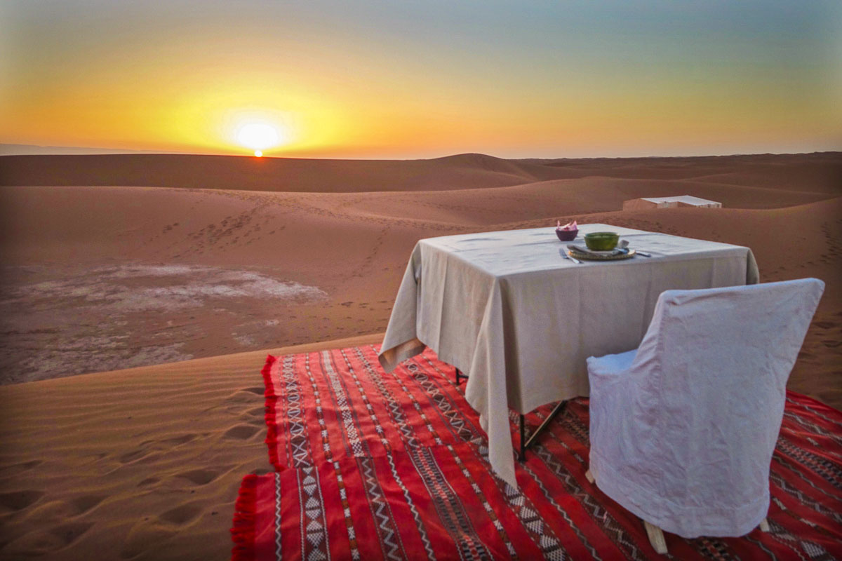 Dar Ahlam tent camp breakfast table at sunrise