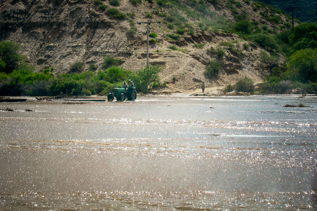 Boys on tractor crossing river