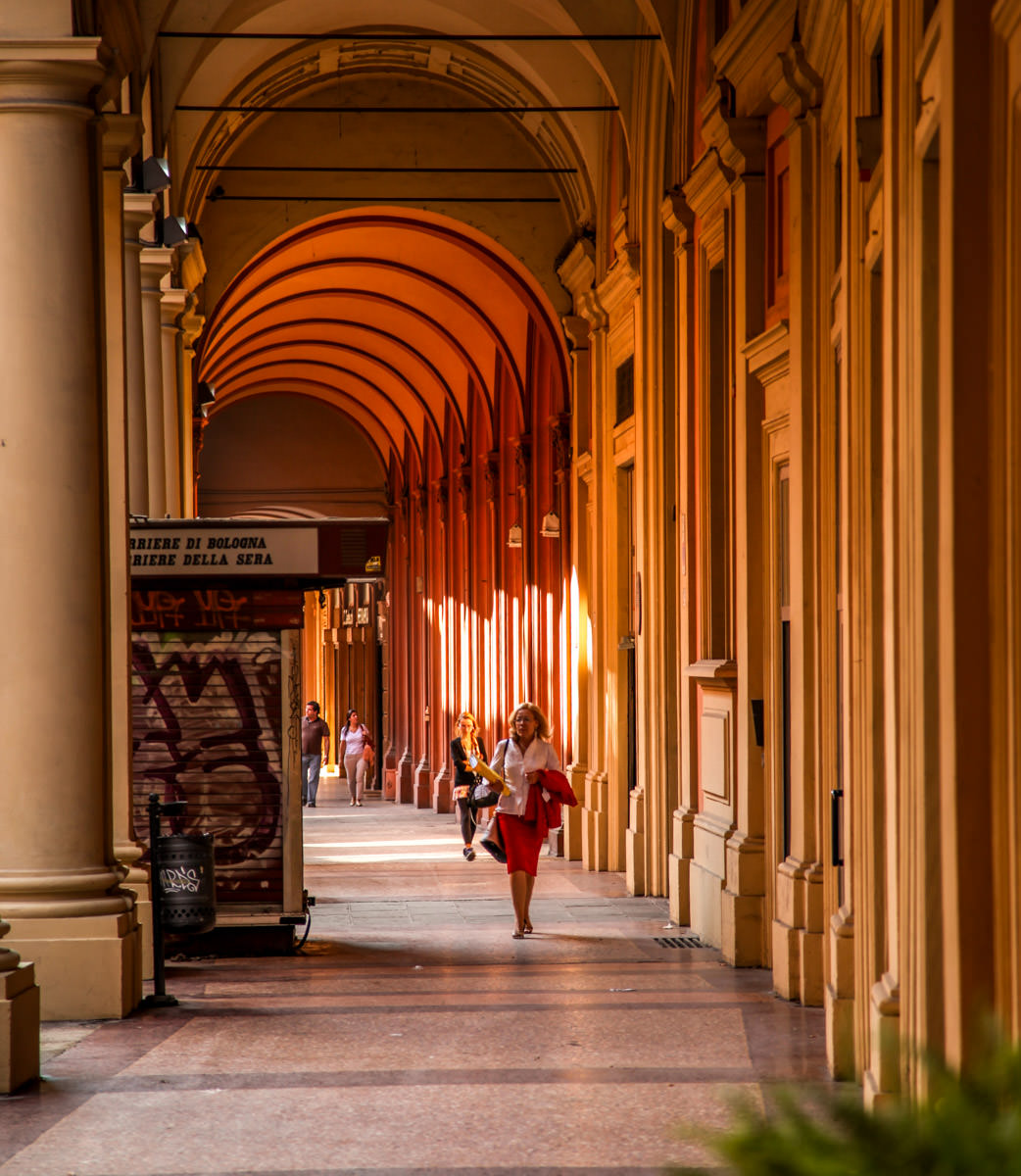 woman walking in portico Bologna