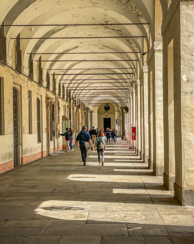 people walking Turin colonnade