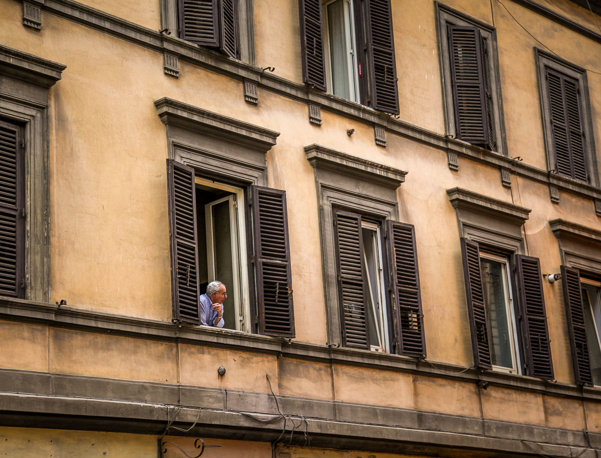 man in window rome